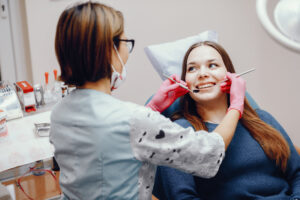 Beautiful girl sitting in the dentist’s office