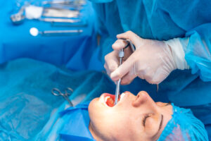 Dental clinic, female dentist doctor applying anesthesia injection before operation