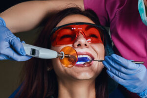 Female dentist treating a patient. A young woman sitting in the dentist’s chair.
