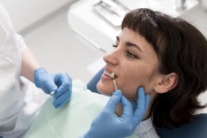 female-patient-having-procedure-done-dentist (1)