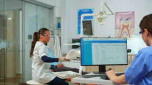 Nurse typing on computer, making appointments